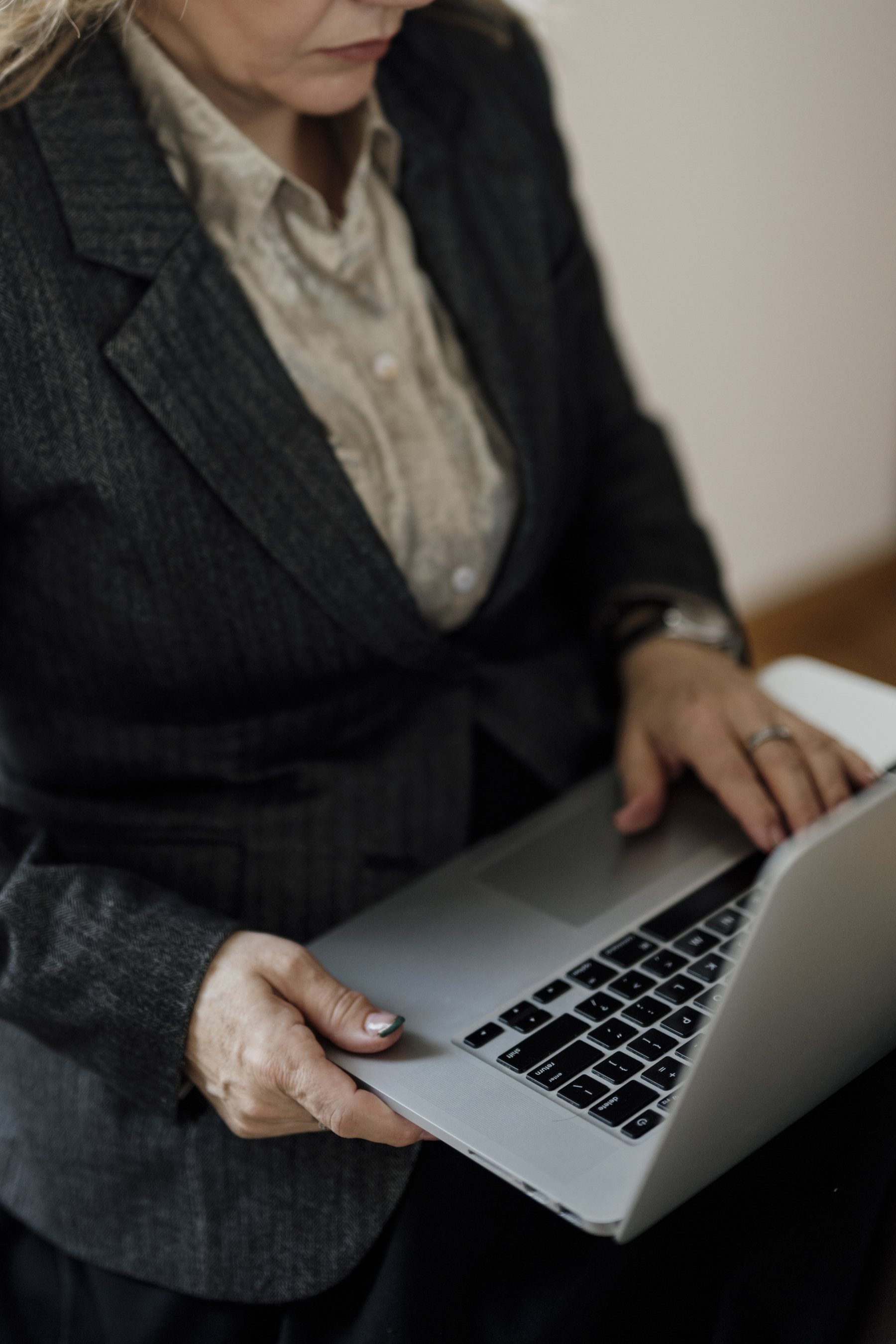 Professional using a laptop in a modern office